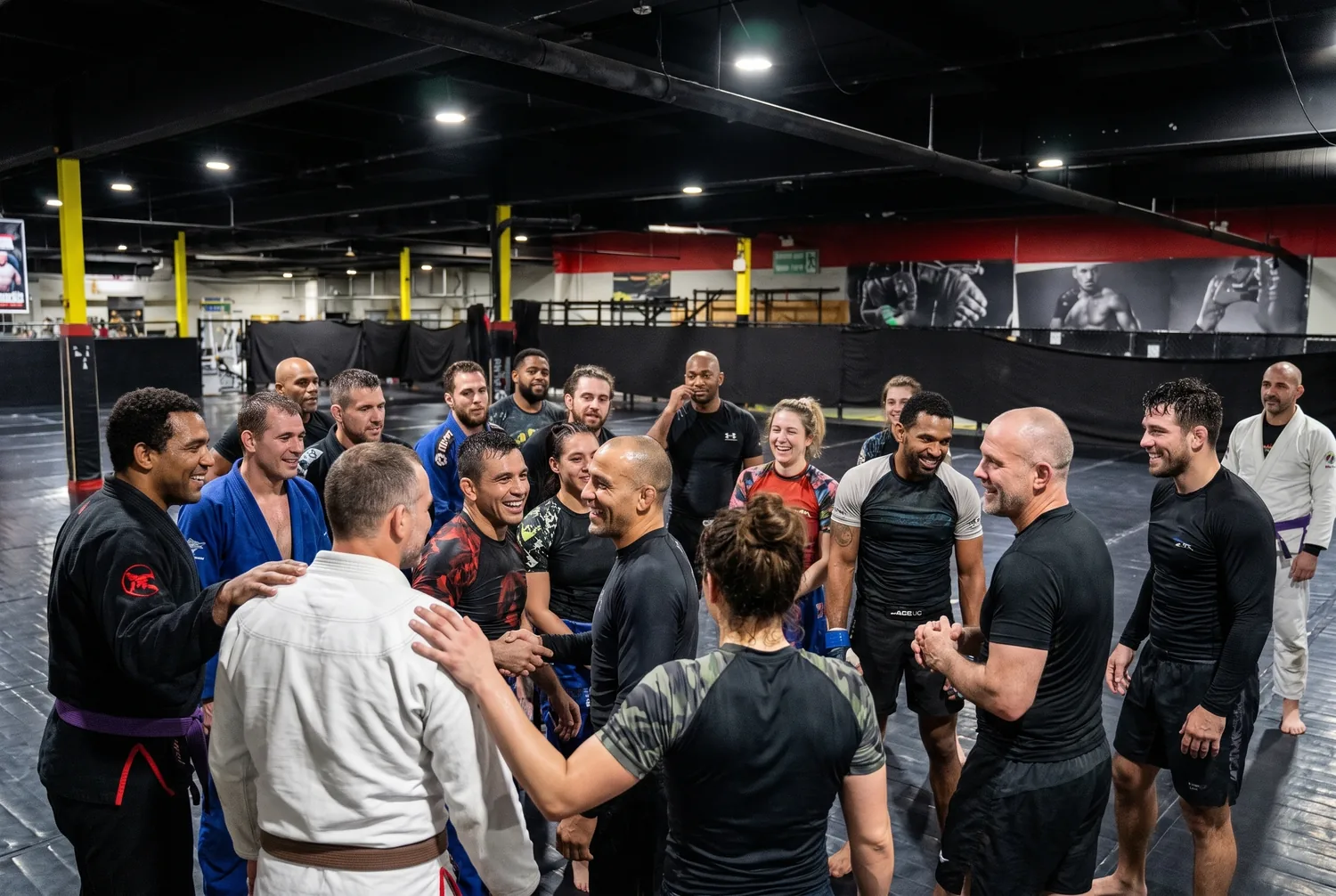 A diverse group of adult training partners together after class at Xtreme Couture