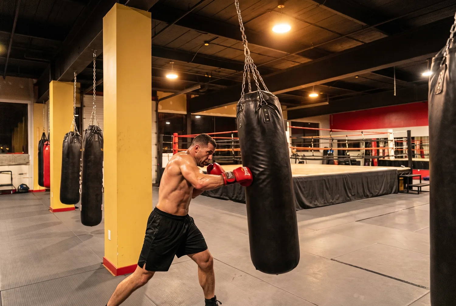 An adult student throwing a hard combination on a heavy bag at Xtreme Couture
