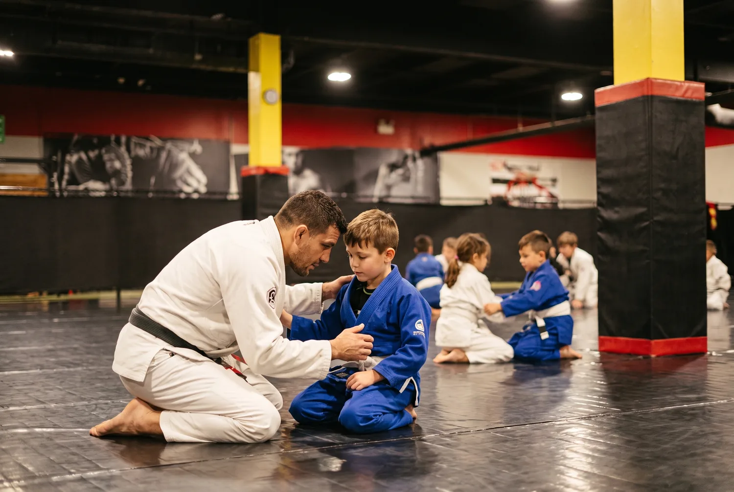 A coach patiently guiding a young student through a technique